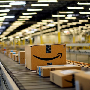 Amazon FBA shipping boxes arranged on a conveyor belt in a fulfillment warehouse