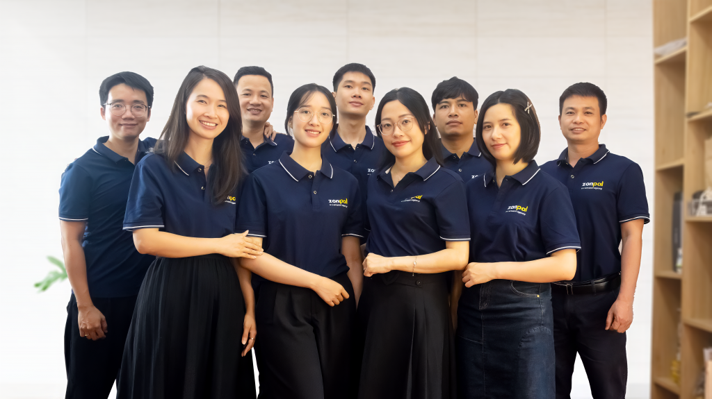 Zonpal team members in blue uniforms posing for group photo representing brand story and company culture